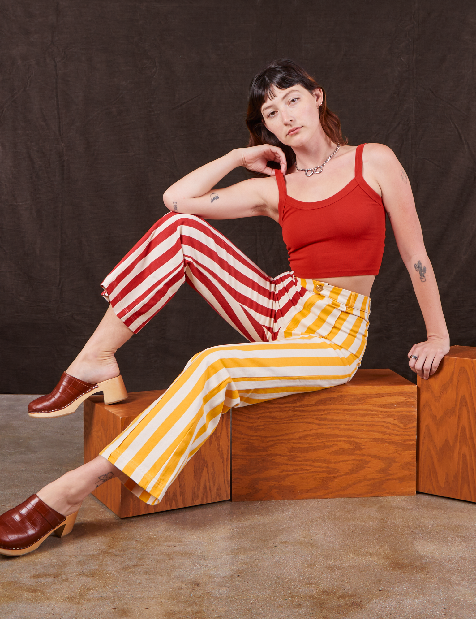 Alex is wearing Western Pants in Ketchup/Mustard Stripes and mustang red Cami