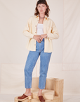 Alex is wearing Oversize Overshirt in Vintage Tee Off-White and light wash Frontier Jeans