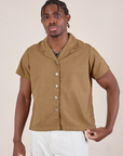 Isaac is 5'10" and wearing M Pantry Button-Up in Desert Brown