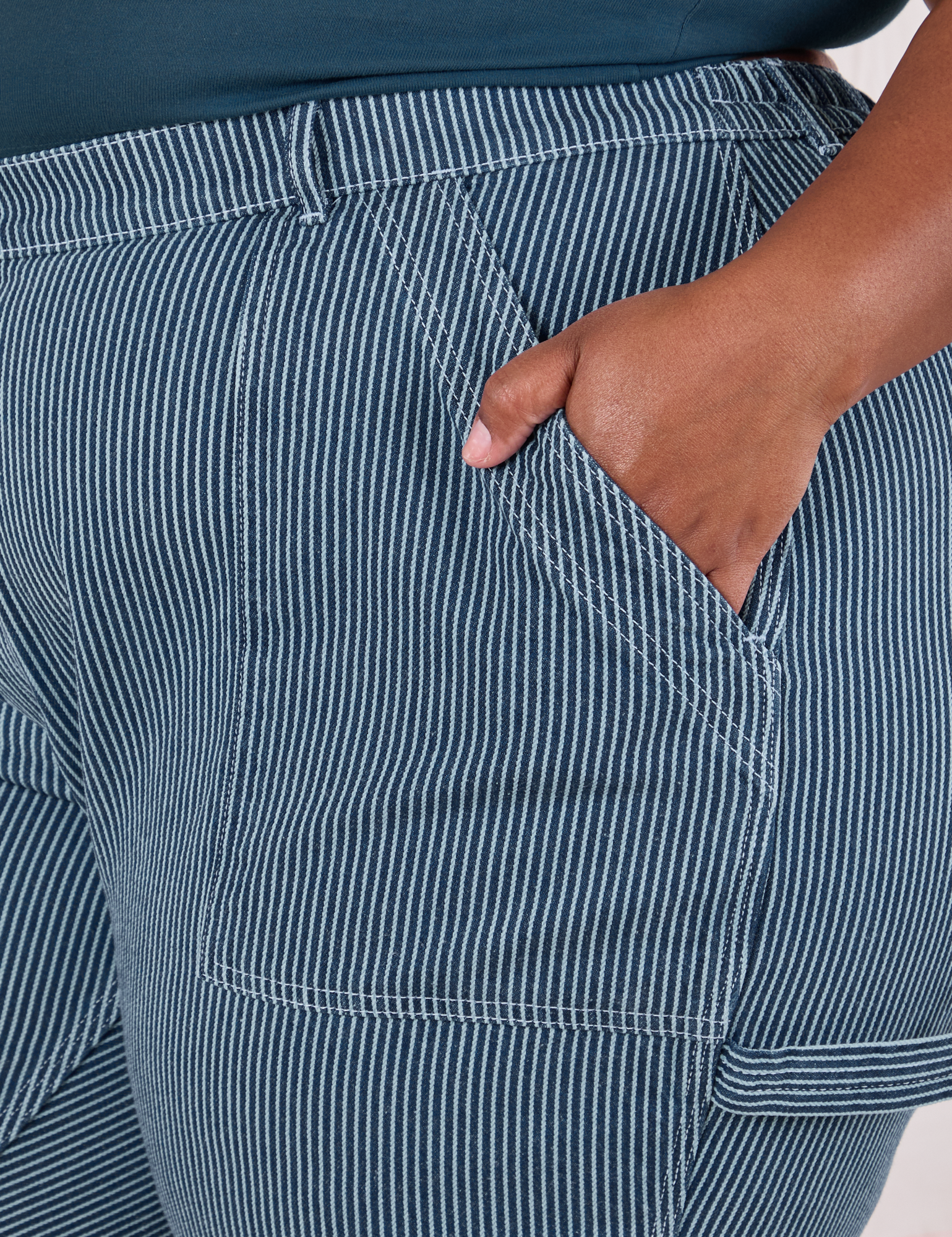 Close up of Morgan's hand in the front pocket of Railroad Carpenter Jeans in Baby Blue