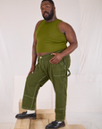 Angled front view of Railroad Carpenter Jeans in Summer Olive
and Muscle Tee on Elijah