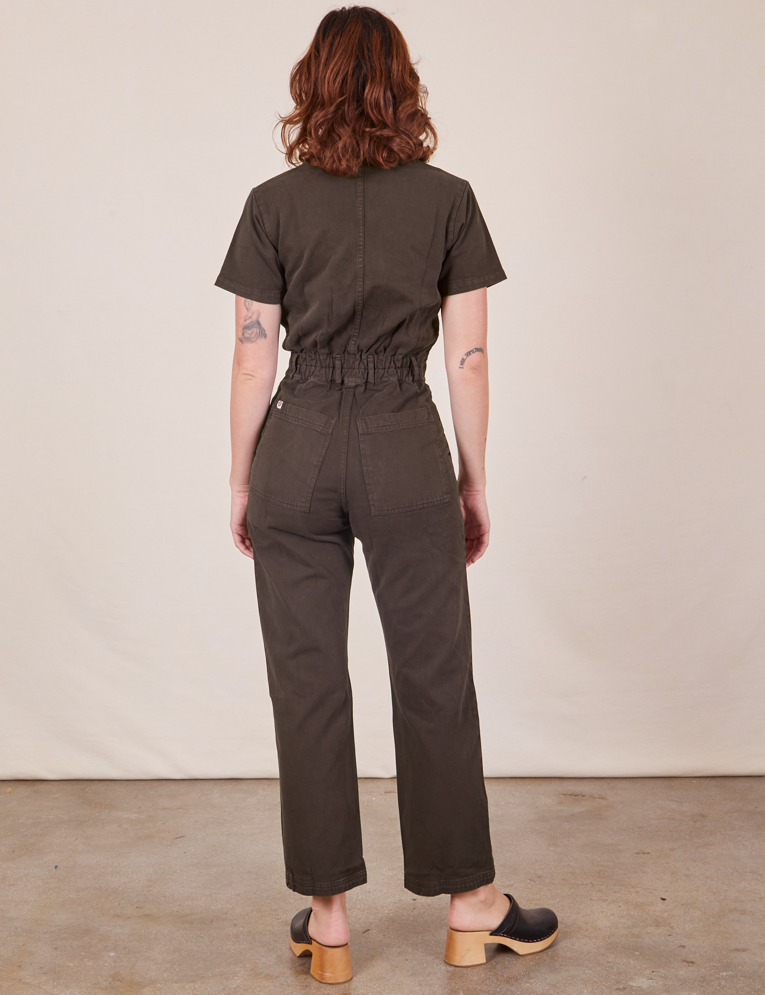 Back view of Short Sleeve Jumpsuit in Espresso Brown worn by Alex