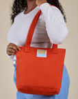 Over-Shoulder Zip Mini Tote in Chili Red worn on shoulder of model