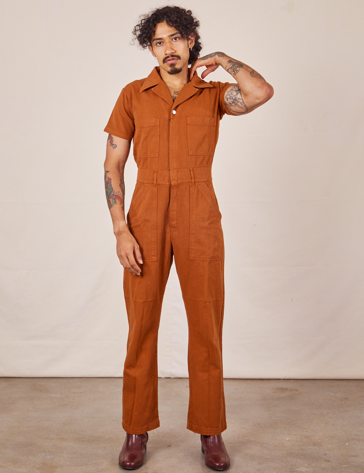 Jesse is 5'7" and wearing S Short Sleeve Jumpsuit in Burnt Terracotta