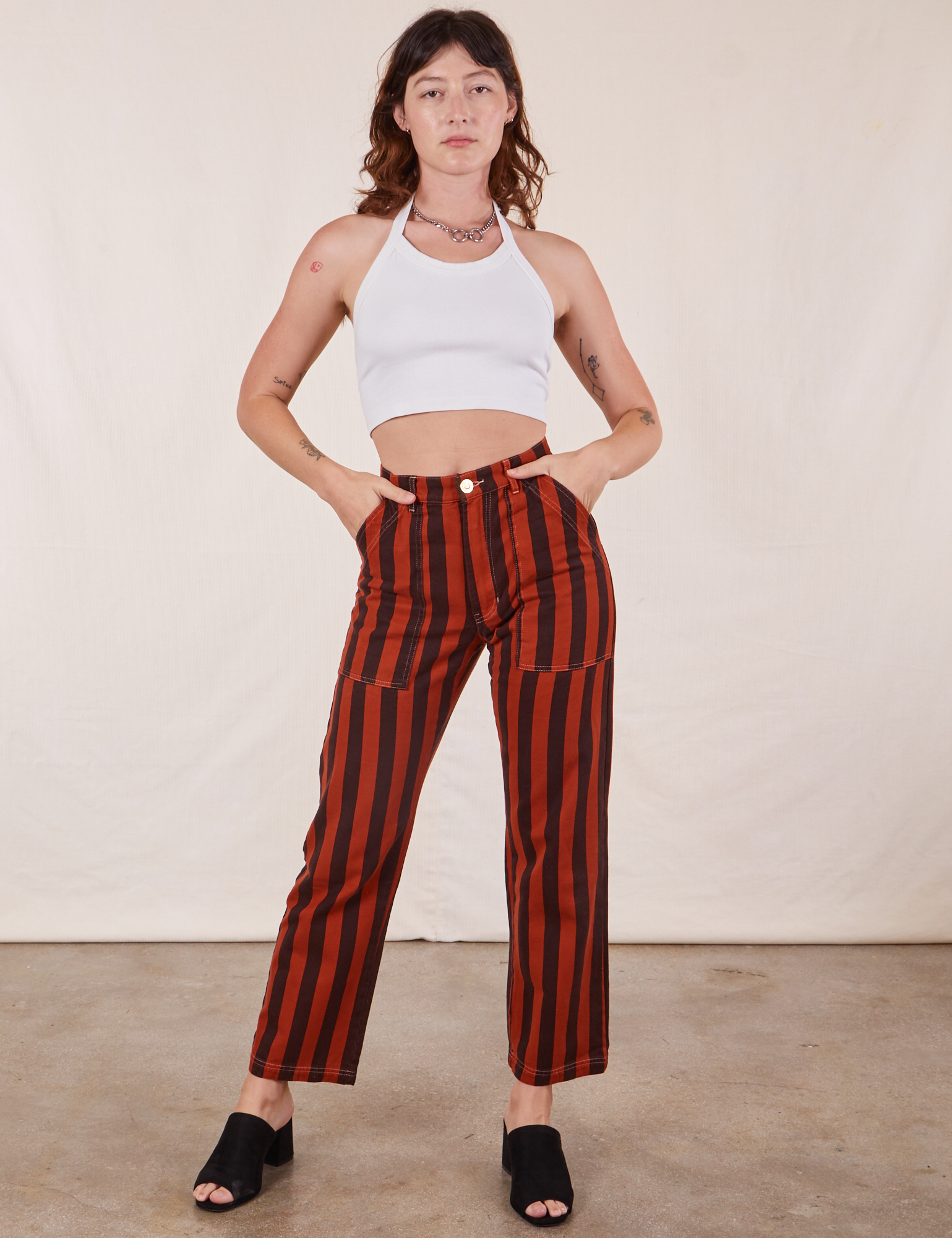 Alex is 5&#39;8&quot; and wearing XS Black Striped Work Pants in Paprika paired with vintage off-white Halter Top