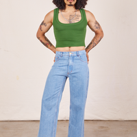 Jesse is wearing Cropped Tank Top in Lawn Green and light wash Sailor Jeans