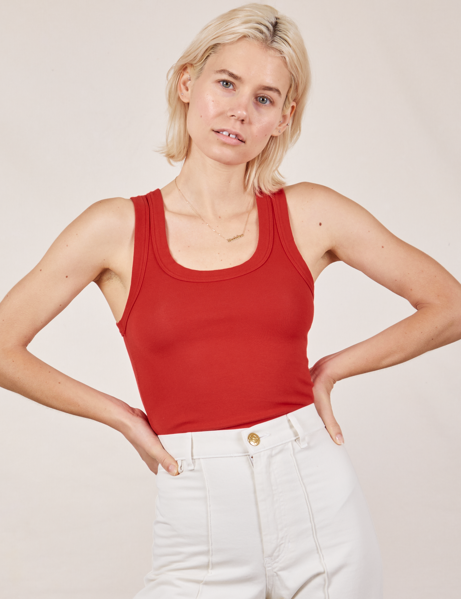 Madeline is wearing Tank Top in Mustang Red tucked into vintage tee off-white Western Pants