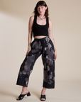 Alex is 5’8” and wearing XXS Magic Waters Drop Pocket Pants in Ink Blot paired with black Cropped Tank