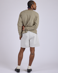Back view of Pleated Trouser Shorts in Dishwater White and khaki grey Long Sleeve Burly Tee on Jerrod