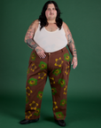 Sam is 5’10” and wearing 4XL Floral Painted Work Pants in Brown paired with a Tank Top in Vintage Tee Off-White