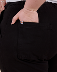 Close up of Ashley's hand in the back pocket of Work Pants in Basic Black