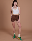 Alex is 5’8” and wearing XXS Classic Work Shorts in Fudgesicle Brown paired with a Cropped Tank in Vintage Tee White