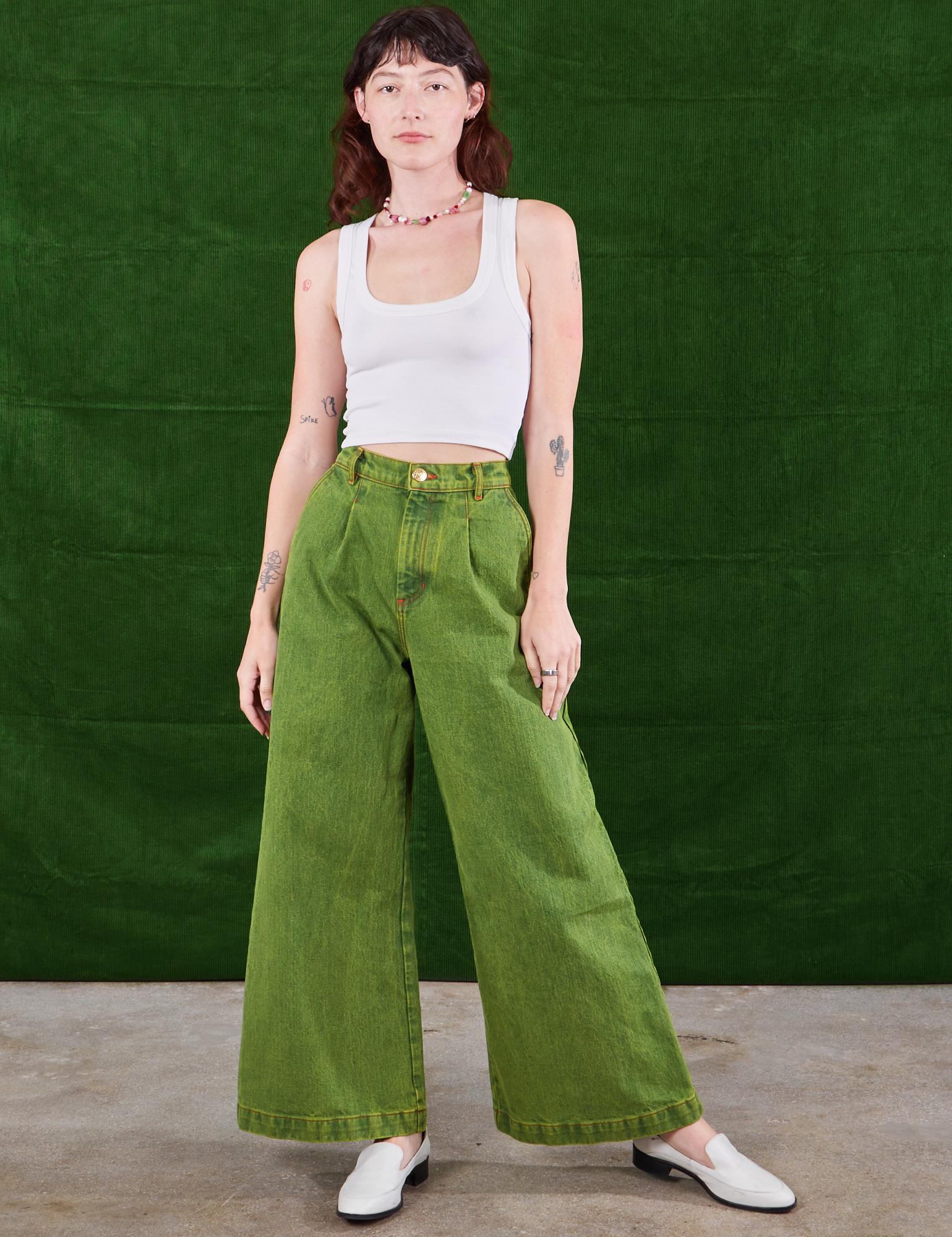 Alex is 5&#39;8&quot; and wearing XXS Overdyed Wide Leg Trousers in Gross Green and Cropped Tank Top in vintage tee off-white 