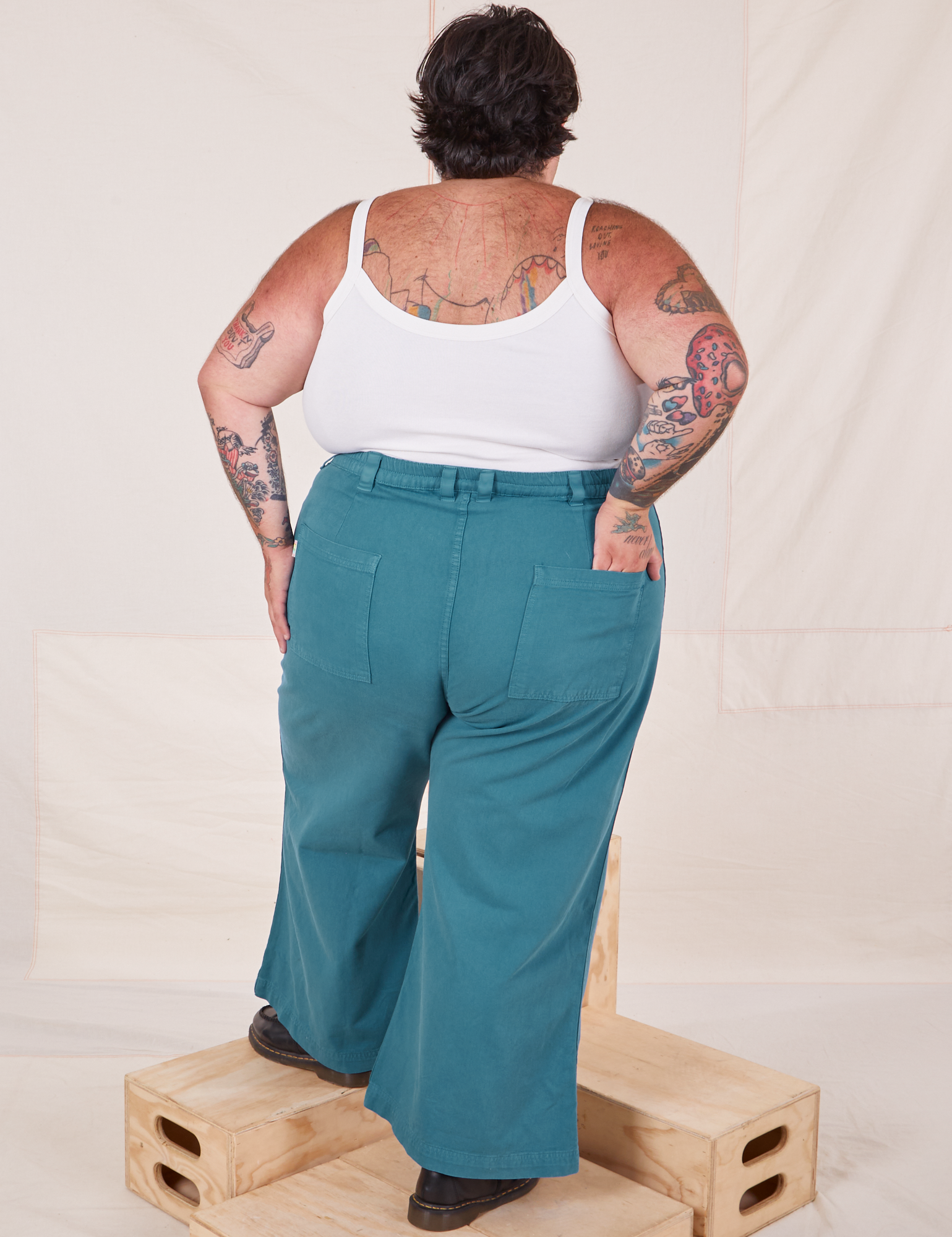 Back view of Bell Bottoms in Marine Blue and Cropped Cami in vintage tee off-white on Sam