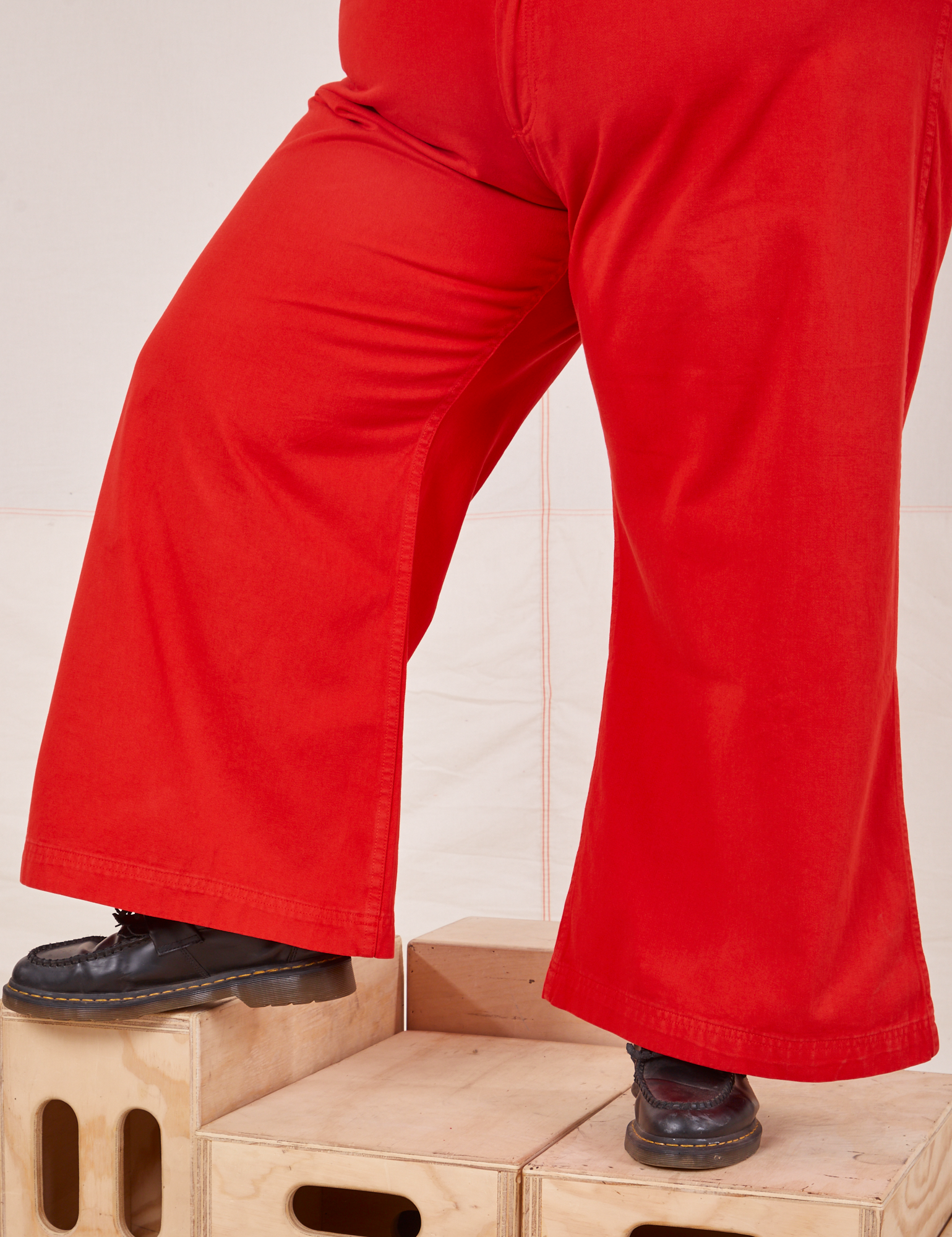 Bell Bottoms in Mustang Red pant leg close up on Sam