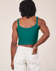 Back view of Cropped Cami in Hunter Green and vintage tee off-white Western Pants worn by Jerrod