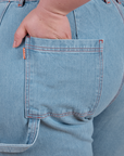 Close up of Ashley's hand in the back pocket of Carpenter Jeans in Light Wash