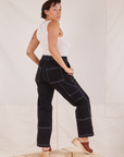 Angled back view of Carpenter Jeans in Black worn by Tiara