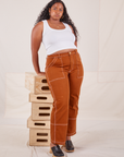 Meghna is wearing Carpenter Jeans in Burnt Terracotta and Cropped Tank Top in vintage tee off-white