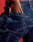 Close up of Meghna's hand in the back pocket of Mid-Rise Carpenter Jeans in Chain Link