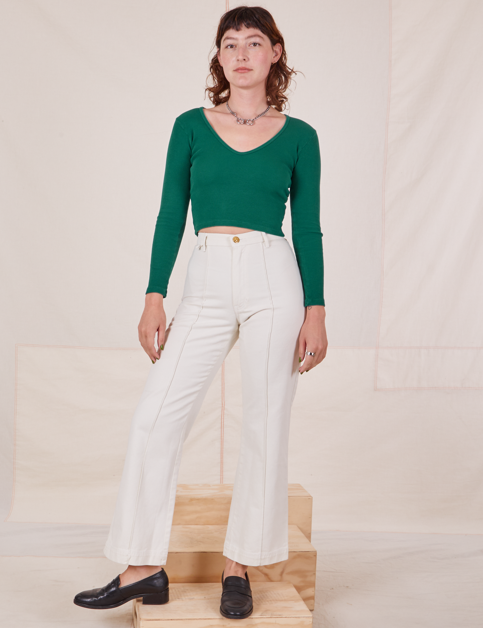 Alex is wearing Long Sleeve V-Neck Tee in Hunter Green and vintage tee off-white Western Pants