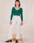 Alex is wearing Long Sleeve V-Neck Tee in Hunter Green and vintage tee off-white Western Pants