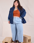 Ashley is wearing Denim Overshirt in Dark Wash, burnt terracotta Cropped Tank and light wash Wide Leg Denim Trousers