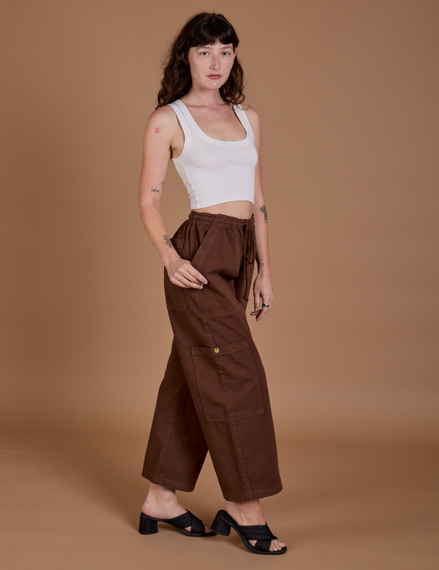 Angled front view of Drop Pocket Cargo Pants in Fudgesicle Brown and Cropped Tank in vintage tee white