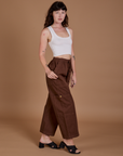 Angled front view of Drop Pocket Cargo Pants in Fudgesicle Brown and Cropped Tank in vintage tee white