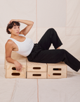 Tiara is wearing Heavyweight Trousers in Basic Black and Cropped Tank Top in vintage tee off-white