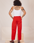 Back view of Heavyweight Trousers in Mustang Red and Cropped Cami in vintage tee off-white worn by Jesse