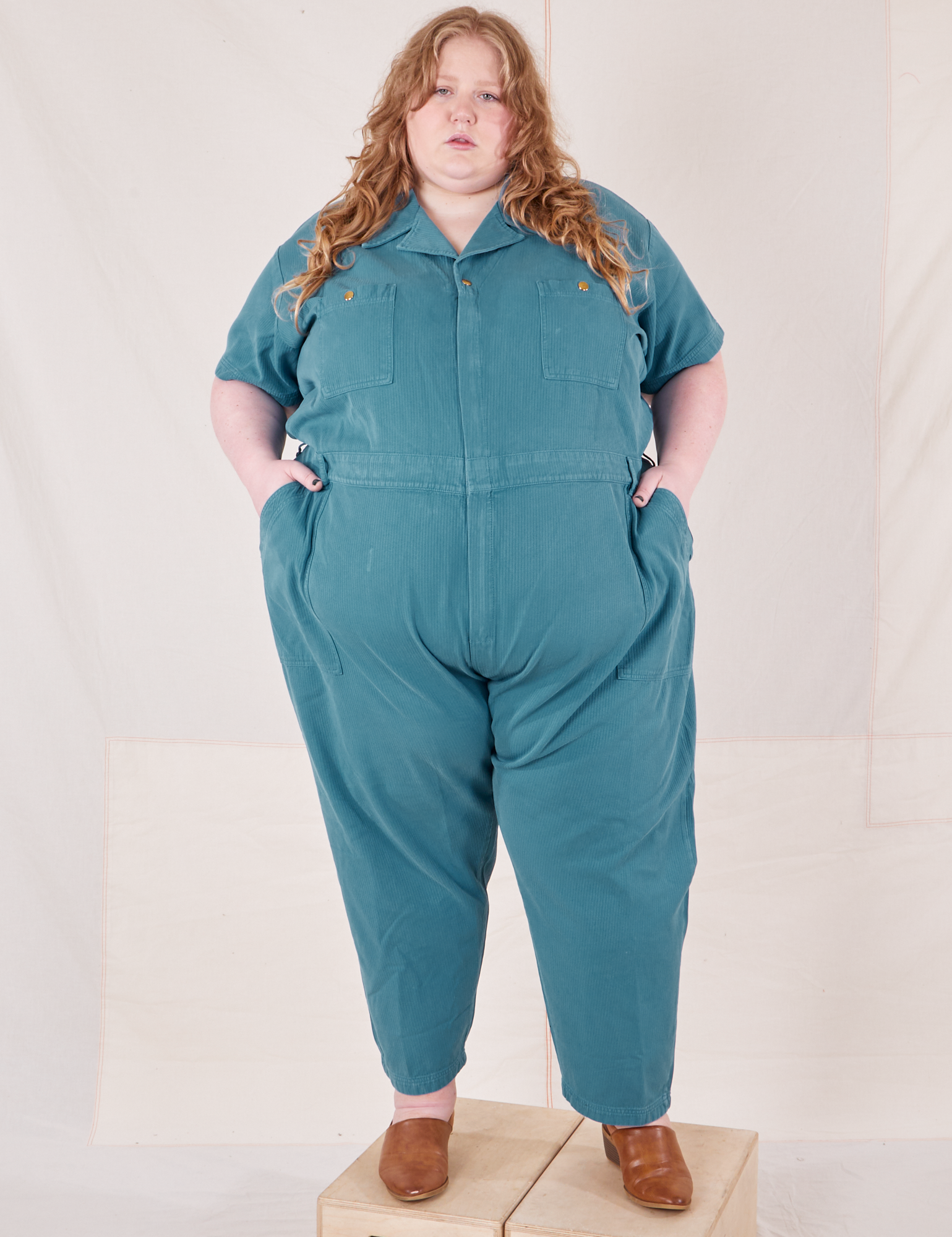 Catie is 5&#39;11&quot; and wearing 5XL Heritage Short Sleeve Jumpsuit in Marine Blue