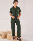 Mika is 5’1” and wearing XXS Heritage Short Sleeve Jumpsuit in Swamp Green