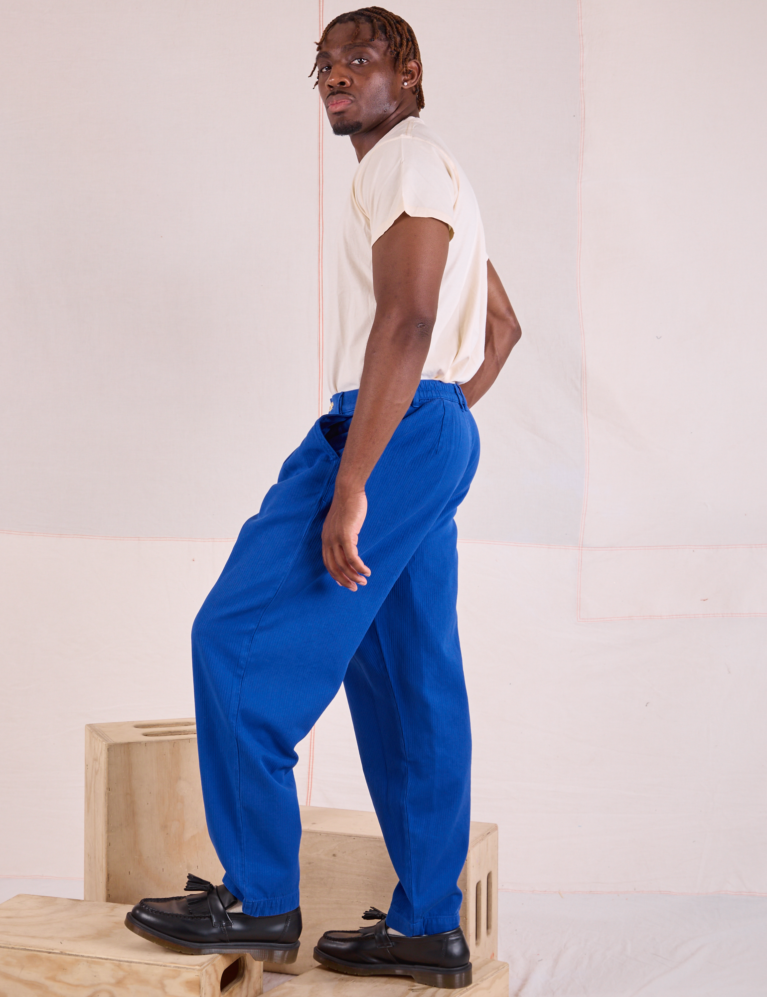 Side view of Heritage Trousers in Royal Blue and Organic Vintage Tee in vintage tee off-white