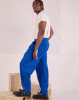 Side view of Heritage Trousers in Royal Blue and Organic Vintage Tee in vintage tee off-white