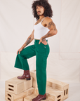 Side view of Bell Bottoms in Hunter Green and vintage off-white Cami on Jesse