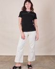 Alex is wearing JV Tee in Basic Black and vintage tee off-white Western Pants