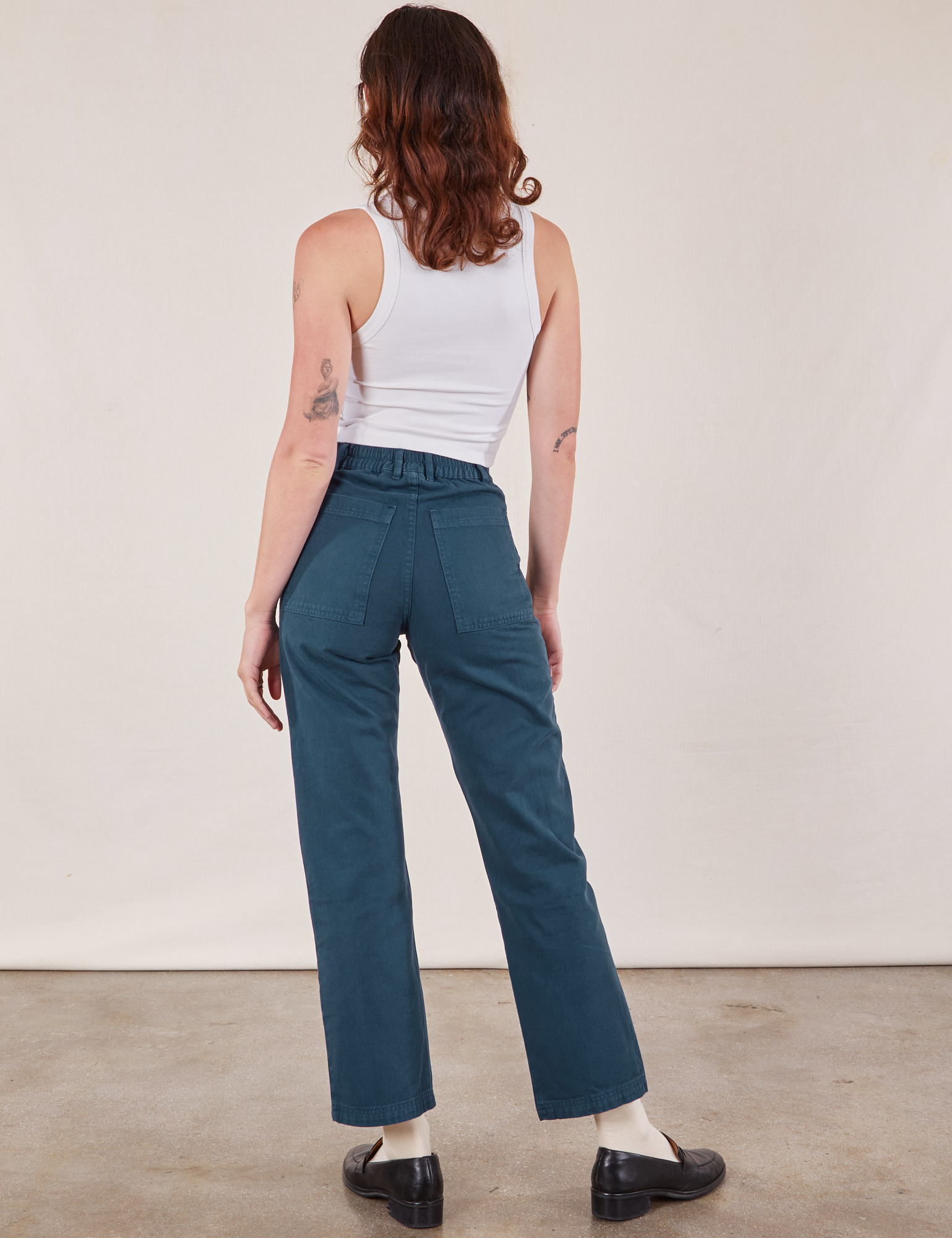 Back view of Work Pants in Lagoon and vintage tee off-white Cropped Tank on Alex