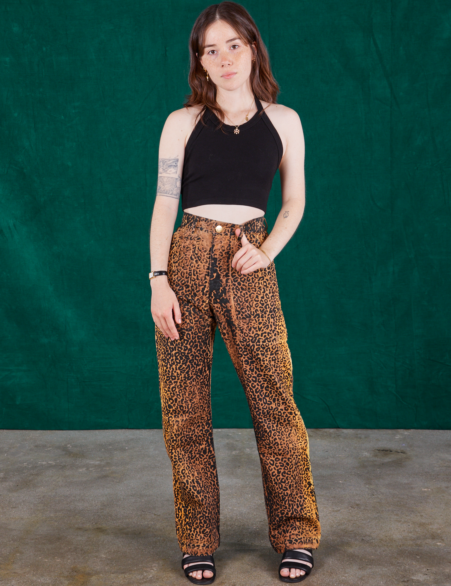 Hana is 5&#39;3&#39; and wearing XXS Leopard Work Pants and black Halter Top