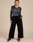 Tiara is waering Long Sleeve Baby Tee in Black Magic Waters and black Drop Pocket Cargo Pants