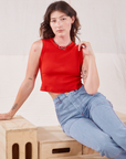 Alex is wearing Muscle Tee in Mustang Red and light wash Carpenter Jeans