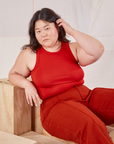 Ashley is wearing Racerback Tank in Mustang Red and paprika Western Pants
