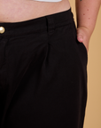 Close up of Juliet's hand in the front pocket of Baggy Mid-Rise Trousers in Basic Black