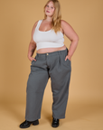 Juliet is 5'7" and wearing 1XL Baggy Mid-Rise Trousers in Slate Grey paired with a vintage tee white Cropped Tank