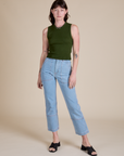 Alex is wearing Muscle Tee in Evergreen paired with light wash Carpenter Jeans