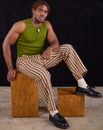 Issac is wearing Work Pants in Autumn Stripe and summer olive Muscle Tee