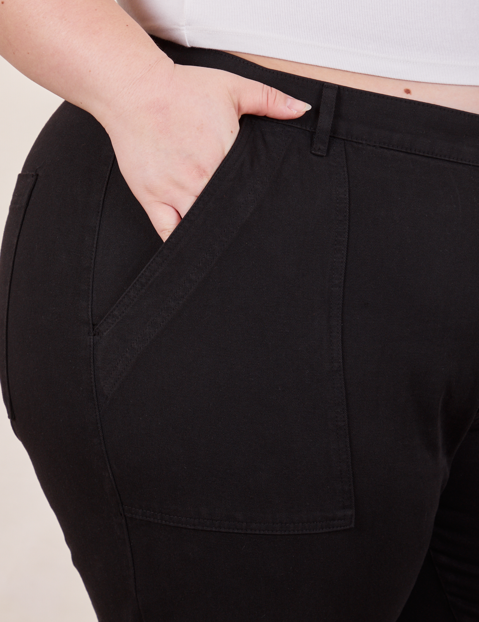 Petite Pencil Pants in Basic Black front pocket close up. Ashley has her hand in the pocket.