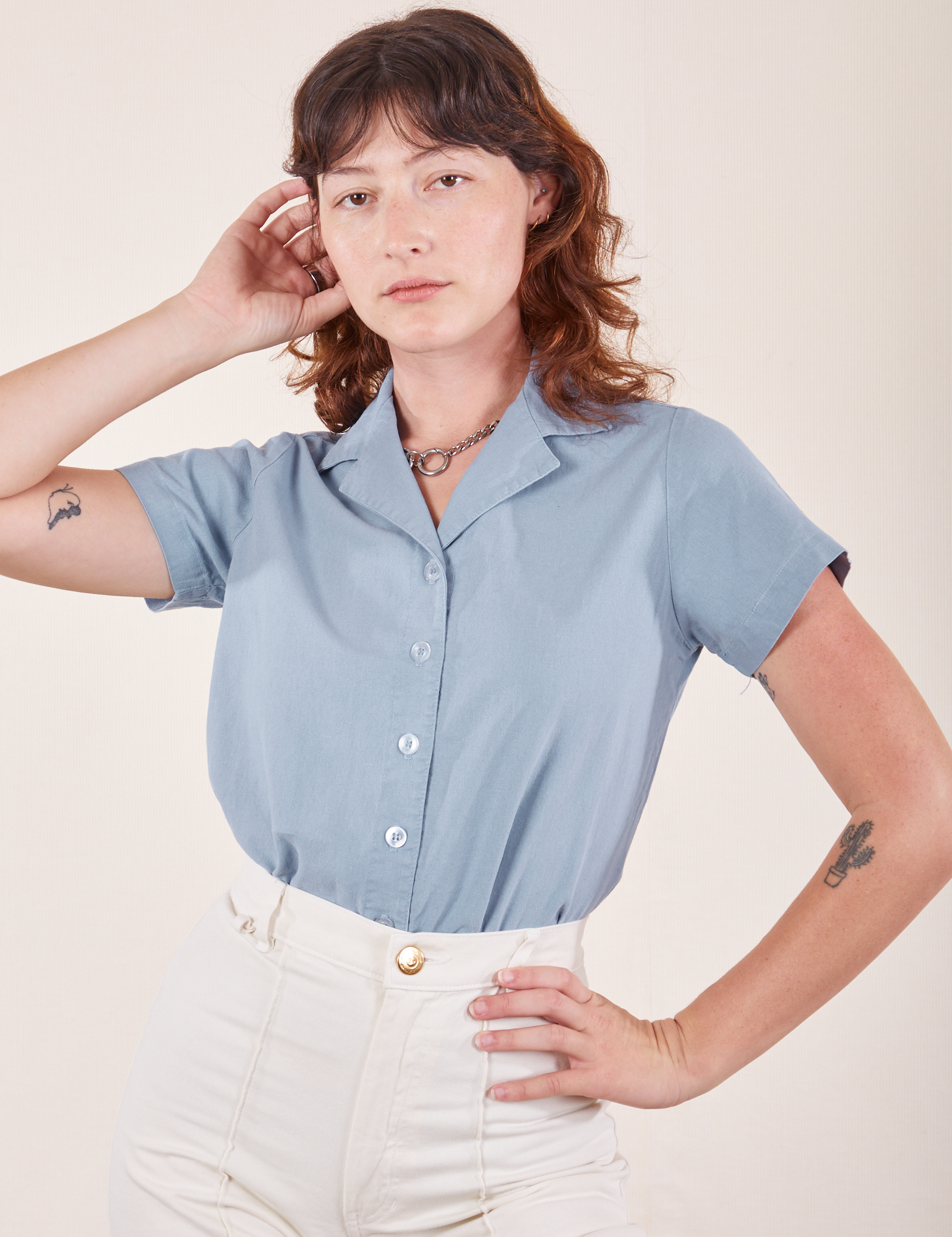 Alex is wearing Pantry Button-Up in Periwinkle tucked into vintage tee off-white Western Pants