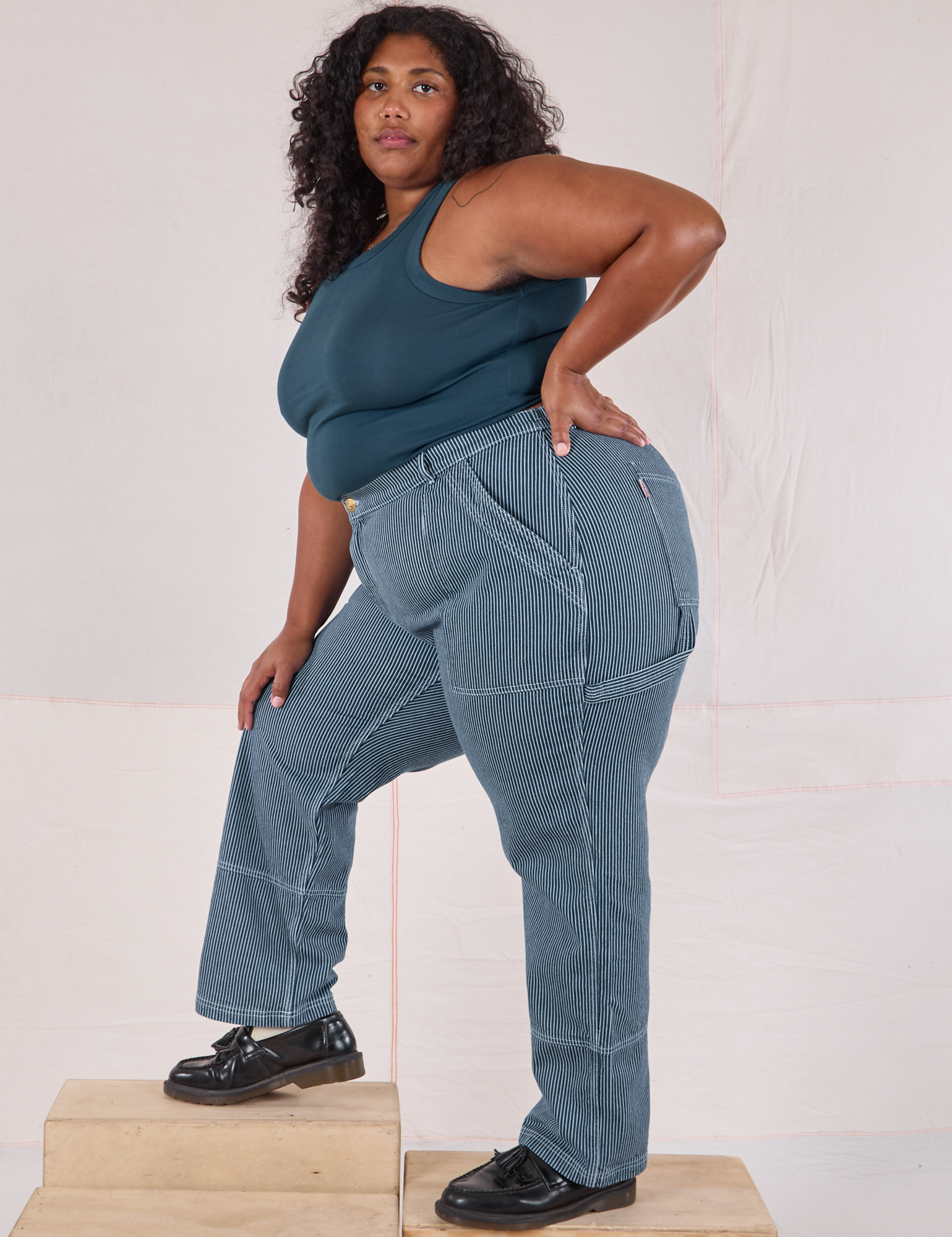 Side view of Railroad Carpenter Jeans in Baby Blue and marine blue Muscle Tee on Morgan