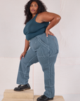 Side view of Railroad Carpenter Jeans in Baby Blue and marine blue Muscle Tee on Morgan